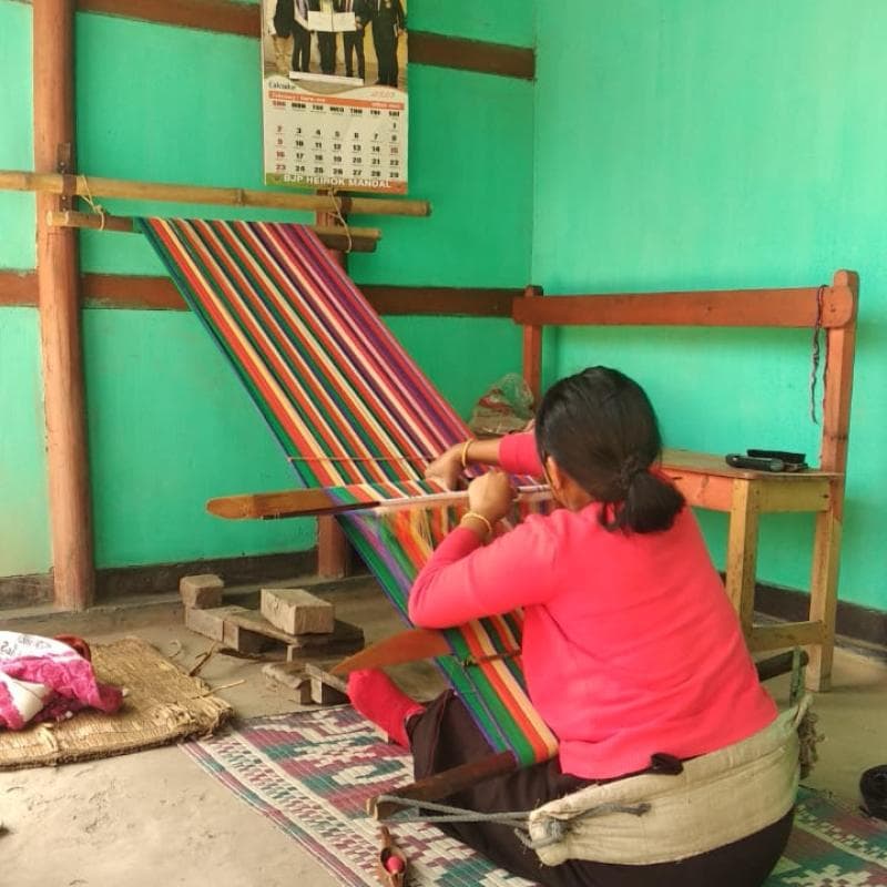 Manipuri woman weaving on traditional handloom